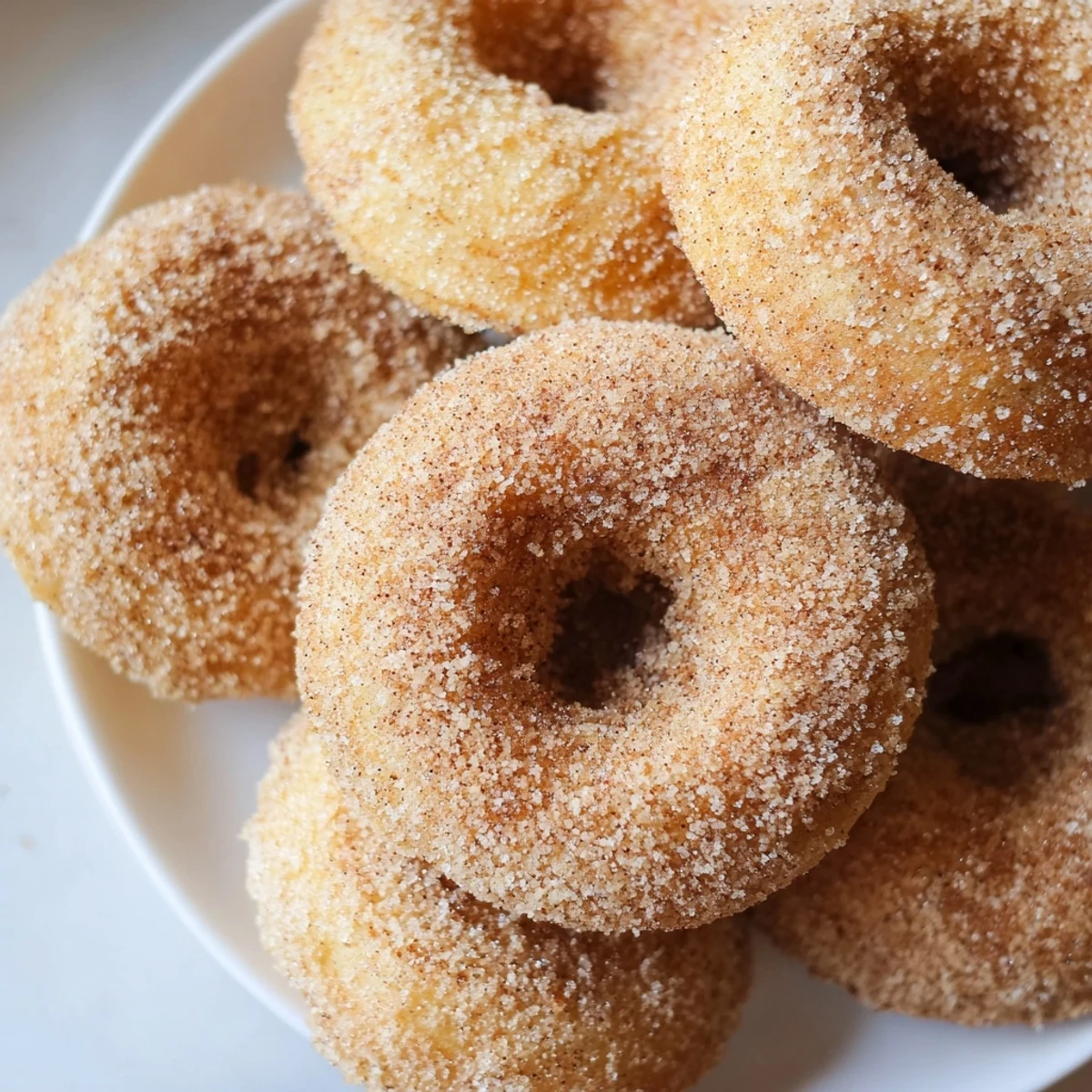 Warm and sugary cinnamon-sugar baked donuts, a comforting American dessert, ready to enjoy.