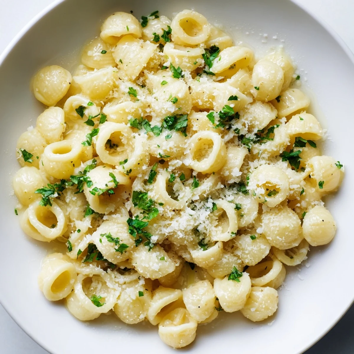 Delicious, steaming ditalini pasta, coated in a luscious sauce, ready for enjoying.