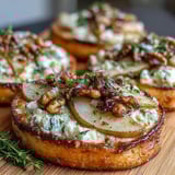 Pear, Gorgonzola, and Pickled Walnut Pizzettes served warm with a drizzle of honey and fresh arugula.