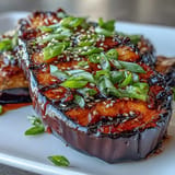Browned, tender Miso Glazed Eggplant ready to be served with sesame seeds.