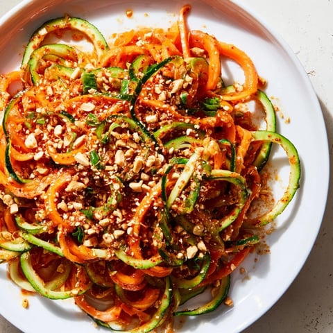 A vibrant Spicy Cucumber Noodle Bowl, ready to serve with refreshing cucumber spirals and a chili glaze.