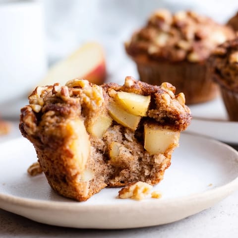 Fluffy Seasonal Spiced Pear and Walnut Muffins, golden brown and smelling heavenly, ready to serve.