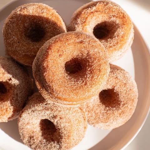 Freshly baked cinnamon-sugar donuts: Fluffy texture and delightful cinnamon aroma filling the kitchen.