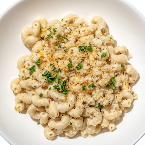 A close-up shot of steaming High-Protein Mac & Cheese, with a rich, velvety cottage cheese sauce.