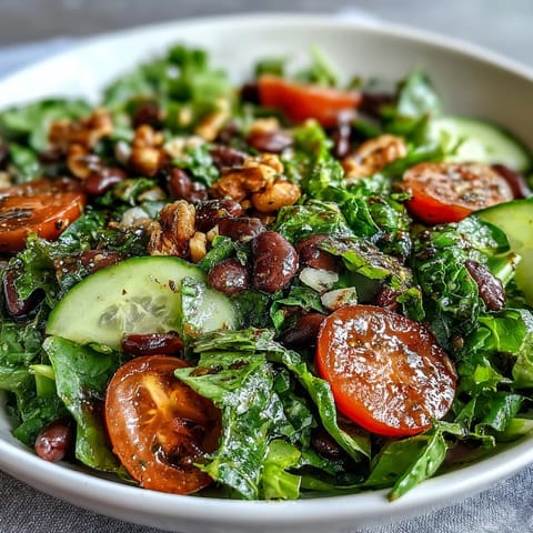 A vibrant Mixed Greens Power Bowl with layered fresh vegetables, protein-rich beans, and crunchy nuts, perfect for a wholesome vegetarian meal.