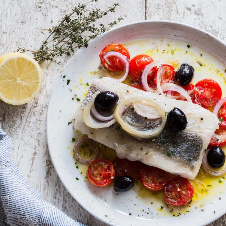 Tender, flaky One-Tray Baked Cod, mingling with olives and vegetables; a flavorful, healthy meal.