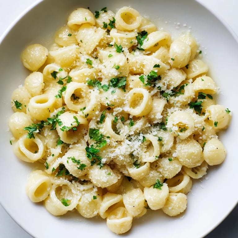 Delicious, steaming ditalini pasta, coated in a luscious sauce, ready for enjoying.