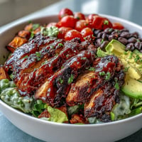 Savory BBQ chicken meal prep bowls with vibrant sweet potato bake.